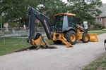 Dale Meyer, Seminary President, using a backhoe during the groundbreaking for the library renovation. by Harold Rau
